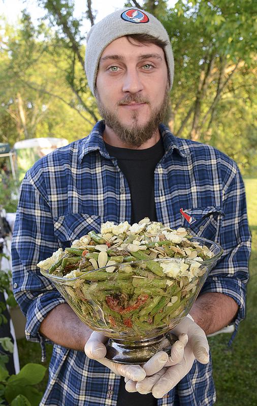 Dillon Collins shows off a salad of asparagus, toasted almonds, and blue cheese in strawberry balsamic dressing.